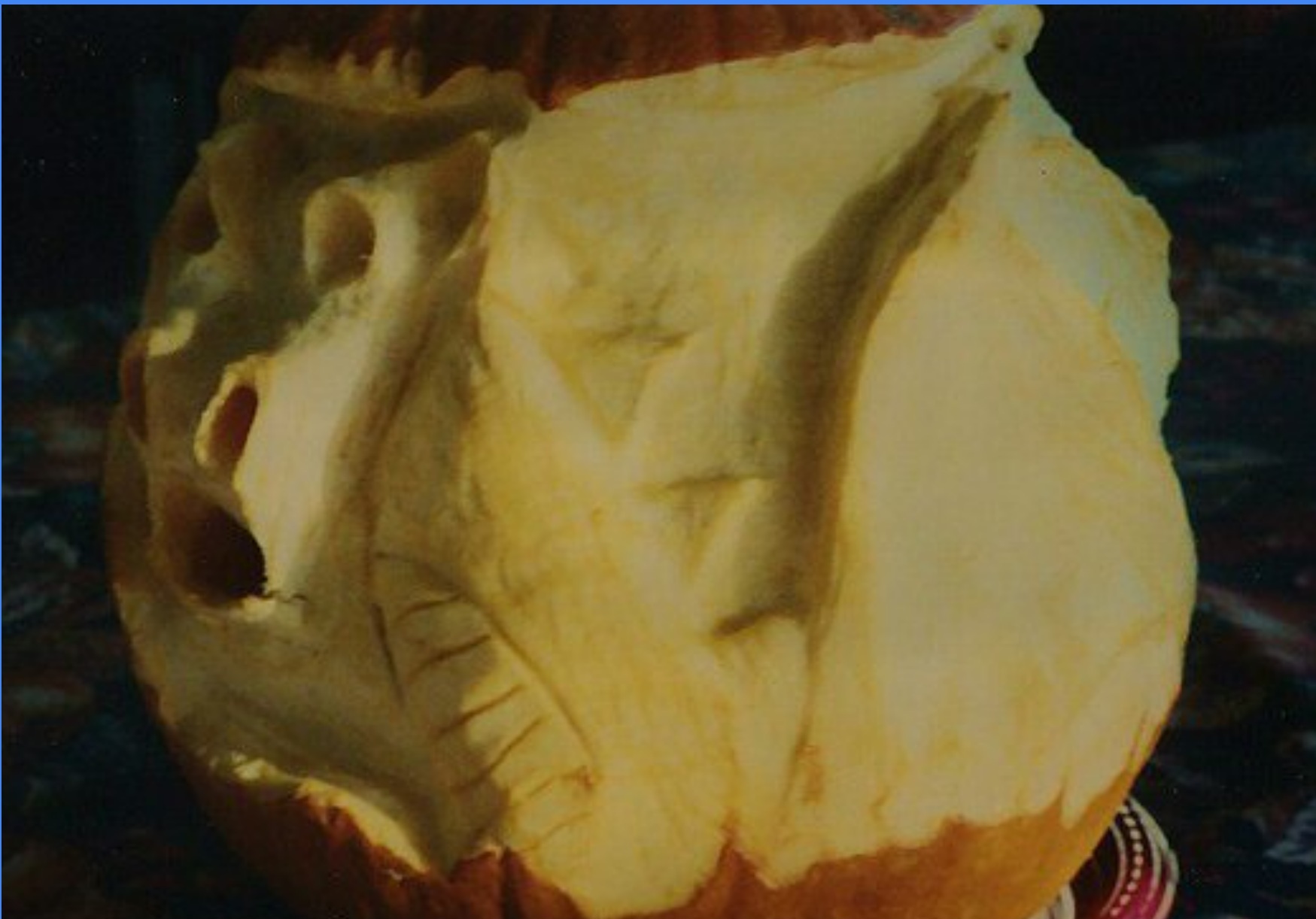 Pumpkin carved in 1999 as a 360-degree dragon, the first carving worked as a continuous wraparound image rather than a front-and-back face.